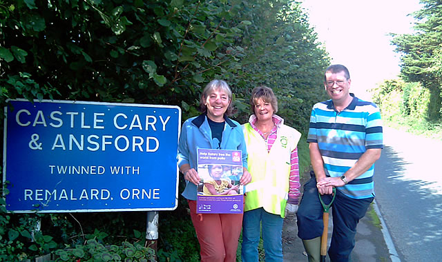 Rotary club members by town sign